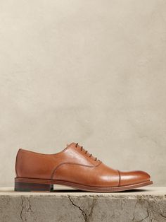 The perfect dress shoe, these timeless leather oxfords have a subtle, cap-toe construction, beautifully crafted for us in Portugal of exceptional, timeless leather.  Leather uppers.  Waxed laces.  Leather soles.  Made in Portugal.  Whole and half sizes.