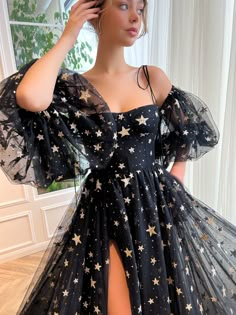 Embody your inner dazzling self with our delicate black tulle gown. Embellished in sequin glittering stars, its medium puffy sleeves and leg slit bringing the perfect balance of elegance and daring. Garden Prom Dresses, Star Prom Dress, Party Dress Patterns, Prom Dress Black, Spaghetti Strap Prom Dress, Prom Dresses Gowns, Formal Evening Dress, Black Prom Dress, Tulle Gown