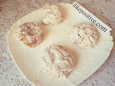 four powdered donuts on a plate with a sign that says the positiveve com