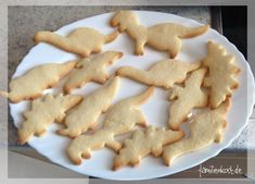 a white plate topped with cut out cookies