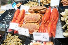 lobsters, clams and other seafood on display at a market