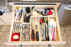 an organized drawer filled with kitchen utensils