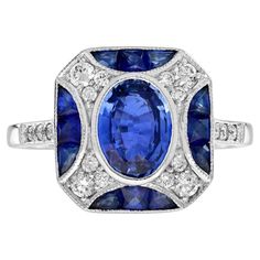 An impressive antique Art Deco inspired 1.45 carat oval blue sapphire with diamond accent. The ring is crafted in 118k white gold and is currently a finger size 7. Low set, comfortable and unique this ring is outstanding. This stunning ring would make the perfect engagement ring or a great additional to any collection. Ring Information Style: Art-deco Metal: 18K White Gold Total weight: 4.90 g. (approx. total weight) Ring size: US 7 (resizable) Center Gemstone(s) Type: Ceylon Sapphire Shape: Oval Size: 8 x 6 mm. Number: 1 Weight: 1.45 Carat (approx. total weight) Accent Gemstone(s) Type: Blue Sapphire Shape: French Cut Size: 2.5 mm. Number: 12 Weight: 1.20 Carat (approx. total weight) Shoulder Gemstones Type: Diamond Shape: Round Average Color: H Average Clarity: SI Size: 1.3 - 2 mm. Numbe 18k Gold Engagement Ring, Number 12, Modern Engagement Rings, Ceylon Sapphire, French Cut, The Perfect Engagement Ring, Art Deco Engagement, Modern Ring, Deco Engagement Ring