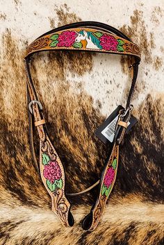 the floral design on this horse's bridle has been hand - painted