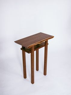 a wooden table sitting on top of a white floor