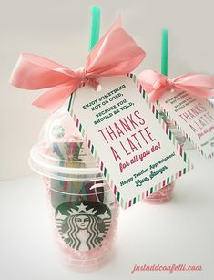 two starbucks cups with pink bows and thank you tags attached to the lids are shown