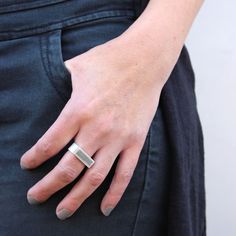 "Rectangle signet ring, suitable for both women and men, integrated with concrete, handmade of sterling silver. Super unique and modern piece of jewelry. This elegant ring is part of BAARA Jewelry's concrete jewelry collection. This collection is inspired by our love of the city landscape and architecture. We use concrete, a seemingly hard and industrial material to create small scale, modern works of art. This signet ring features a rectangle silver frame, filled with concrete, on a wide silver Modern Rectangular Signet Ring For Promise, Modern Rectangular Signet Promise Ring, Modern Everyday Rings With Rectangular Stone, Modern Everyday Ring With Rectangular Stone, Modern Silver Engraved Ring For Everyday, Modern Silver Rings With Rectangular Stone, Modern Silver Ring With Rectangular Stone, Minimalist Everyday Rings With Rectangular Stone, Minimalist Everyday Ring With Rectangular Stone