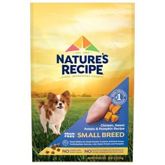 a bag of small breed chicken and pumpkin recipe dog food on the grass with an image of a puppy standing next to it