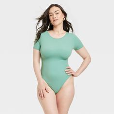 This 4-Way Stretch Short-Sleeve Bodysuit from Auden™ adds an effortlessly cozy option to your wardrobe. Made from lightweight fabric with spandex, this short-sleeve bodysuit in green features a round neck plus a cotton gusset to help you stay cool and comfortable. Great for wearing under a variety of outfits, the bodysuit also features a four-way stretch design for flexible wear. Auden™: Comfort true to every shape & hue. Green Short Sleeve Swimwear With Stretch, Stretch Short Sleeve Bodysuit For Loungewear, Short Sleeve Bodysuit For Loungewear, Solid Color Short Sleeve Bodysuit For Loungewear, Solid Color Snug Fit Bodysuit For Loungewear, Green Fitted Short Sleeve Bodysuit Casual, Snug Fit Solid Color Bodysuit For Loungewear, Solid Casual Bodysuit With Snug Fit, Loungewear Snug Fit Bodysuit