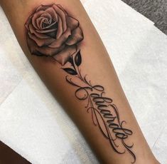 a rose with the word faith written in cursive writing on its side arm