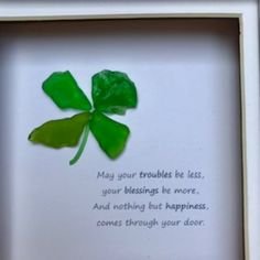 a four leaf clover in a white frame with a poem written below it that reads may your troubles be less, your blessing be more and nothing but happiness comes