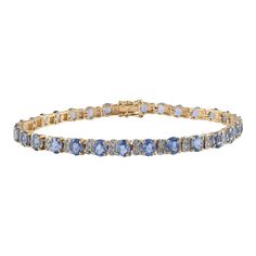 This is part of Chairish’s Fine Jewelry assortment.  Blue Sapphire and Diamond Tennis Bracelet in 14K Gold showcases 31 endlessly sparkling natural  sapphires weighing 10.39 carats and diamonds weighing 0.75 carats. It measures 7.5 inches long in length.  Sapphire stimulates concentration and reduces stress. Designed with perfect oval cut blue sapphire with two diamond in between each sapphire to make you stand out on any occasion or event. The elegant style complements the attire beautifully an Luxury Blue Diamond Bracelet With Accents, Diamond Bracelet With Gemstone Accents, Fine Jewelry Diamond Bracelet With Gemstone Accents, Luxury Blue Gemstone Diamond Bracelet, Blue Diamond Bracelet With Brilliant Cut, Blue Oval Diamond Bracelet With Jewels, Blue Oval Sapphire Diamond Bracelet, Blue Brilliant Cut Diamond Bracelet, Formal Blue Tanzanite Bracelets