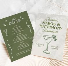 two wedding programs are sitting next to each other on a table with white and green paper