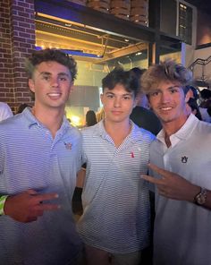 three young men standing next to each other