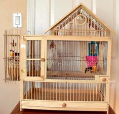 a wooden bird cage sitting on top of a table