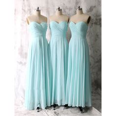 three bridesmaid dresses on mannequins in front of a white wall