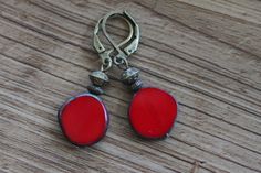 Red Earrings, Czech Glass earrings, Dangle, Drop, Earrings, Red Jewelry, Gift For women Color : Red Picasso Czech glass round beads with polished sides. Finish : Antiqued brass findings   Size : 1.5 inches including the antiqued brass lever backs Ear wires : Antiqued brass lever backs Czech glass earrings section : https://www.etsy.com/shop/NtikArtJewelry?section_id=16062218&ref=shopsection_leftnav_5 Thanks for looking ! Nickel-free Red Czech Glass Jewelry, Red Round Metal Earrings, Red Dangle Earrings With Lever Back Ear Wires, Elegant Red Czech Glass Earrings, Red Czech Glass Jewelry, Nickel-free Red Round Earrings, Nickel Free Red Earrings, Nickel-free Red Drop Earrings, Nickel-free Red Drop Earrings Jewelry