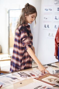 a woman looking at photos on a table