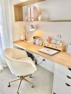 a white chair sitting in front of a wooden desk