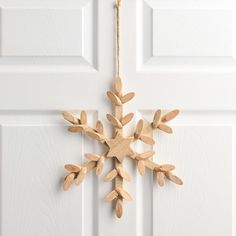 a wooden snowflake hanging from a door