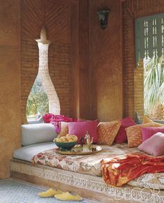 a living room filled with lots of furniture and pillows