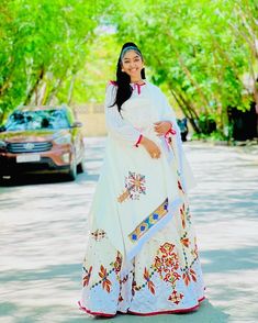 This Habesha Kemis is a true masterpiece of traditional Ethiopian fashion, with its exquisite Menen fabric and intricate Tilf design. The Menen fabric is renowned for its softness and durability, making this Kemis not only beautiful but also comfortable to wear. The Tilf design is intricate and delicate, with a pattern that is both modern and traditional, with clean lines and bold shapes that create a unique and eye-catching look. The Tilf design extends down the front of the Kemis, creating a v White Bollywood Style Traditional Drape Dress, Festive Maxi Dress With Traditional Patterns For Eid, White Bohemian Gown For Eid, Traditional Pattern Kaftan For Wedding And Navratri, Wedding Kaftan With Traditional Patterns For Navratri, Resham Embroidered Dresses For Eid, Traditional Wedding Kaftan For Navratri, White Cutdana Dress For Traditional Ceremonies, White Dress With Traditional Patterns For Eid