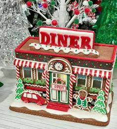 a christmas scene with a diner and trees in the background