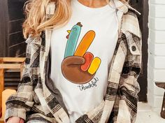 Cute Turkey Shirt, Oversized Fall Shirt, Thankful Turkey Peace Shirt, Thankful Fall Shirt, Turkey Thanksgiving Shirt, Peace Out Turkey Tee Tie to the side, tucked in the front, paired with your favorite jeans and you are set for the weekend of comfort.  This updated unisex essential fits like a well-loved favorite, featuring an irresistibly soft poly-cotton blend, crew neck and short sleeves. The design is printed with digital in.  The shirt in the picture may be a little different then the actual shirt due to lighting in the picture. ------------------------------ How to wash a DTG Printed shirt? Turn your T-shirt inside out. Fill your washing machine with cold water. Use the correct amount of soap and DO NOT use Bleach. Use the gentle cycle on your washing machine. Air Dry your t-shirt o Turkey Pieces, Thankful Turkey, Cute Turkey, Turkey Shirts, Turkey Thanksgiving, Shirt Tie, Thanksgiving Shirt, Fall Shirt, Thanksgiving Shirts