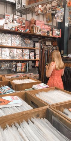 a woman is looking through files in a store