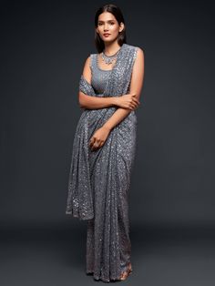 Our Grey georgette sequinned saree is accompanied by an unstitched blouse. This piece is extremely elegant that makes it perfect for all events. It’s a staple piece for your wardrobe. It defies age making it a winner across all age groups. Standard and Customized blouse stitching available for an additional fee. Please note this blouse can be stitched up to a size 44, and cannot be made with sleeves. For the customized option, our team will reach out to you after the order is placed to take your Glitter Saree, Saree In Black, Sequins Saree, Indian Bridesmaids, Saree Party Wear, Sequin Saree, Grey Saree, Bridesmaid Saree, Party Sarees