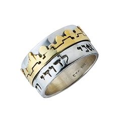 two tone gold and silver ring with hearts on the inside, set against a white background