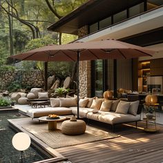 an outdoor living area with couches, tables and umbrellas on the decking