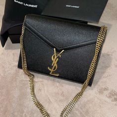 Just In Time For The Holidays! Authentic Ysl Monogrammed Cassandra Bag In Like New Condition With Minor Interior Scuffs. Exterior And Brass Ysl Closure Are In Mint Condition. Description: Black Exterior, Maroon Interior With Gold Chain Strap. Comes With Everything Pictured. Additional Pictures Available Upon Request. 100% Authentic. Yves Saint Laurent Bags, Black Exterior, Chain Strap, Mint Condition, Gold Chains, Like New, Yves Saint Laurent, Saint Laurent, Bag Lady