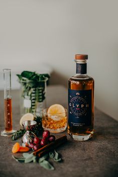 a bottle of gin sits on a table next to some ingredients