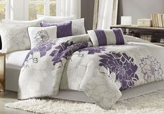 a bed with purple and white flowers on it