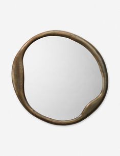 a round mirror hanging on the wall