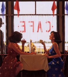 two women sitting at a table in front of a sign that says cafe on it