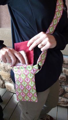 a woman is holding a small purse in her hands