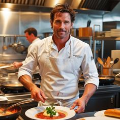 a man standing in front of a plate of food on top of a counter next to other plates