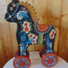 a wooden toy horse sitting on top of a table