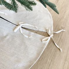 a pair of scissors on top of a piece of cloth next to a christmas tree