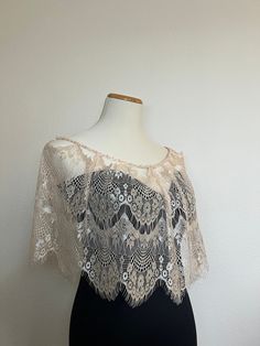 "Lace wedding dress topper. Bridal capelet.  Fancy Lace wedding cape.  Shoulder cover-up stole.  Bridal Lace bolero.  Bridal capelet.  Off-shoulder stole. Special occasion shawl.  Bridal bolero.  Available in two colors ( Black or Cream)  Black Lace has an adjustable chiffon ribbon tie.  Cream lace has a pearl beaded ribbon around the shoulder  Length : 11\"  Shoulder perimeter: 33\"" Elegant Capelet For Party, Elegant Party Capelet, Fitted Shawl For Mother Of The Bride, Elegant Lace Mother Of The Bride Dress For Ceremony, Fitted Lace Shawl For Wedding, Cream Shawl For Evening, Elegant Cream Shawl For Evening, Elegant Lace Trim Shawl For Weddings, Elegant Fitted Lace Shawl