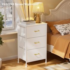 a bedroom with a bed, nightstand and lamp on it's side table in front of a window