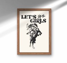 a framed poster with the words let's go girls in black and white on it