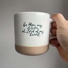 a hand holding a coffee mug with writing on it that says, be if you may sit down and drink out of my heart