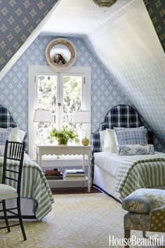 two beds in a room with blue and white walls