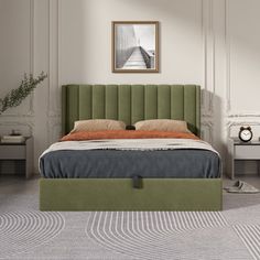 a bed with a green headboard sitting in a bedroom next to a table and two nightstands