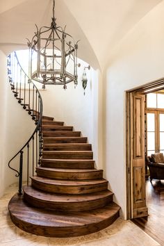 a painting of a staircase in a house with a light fixture hanging from the ceiling