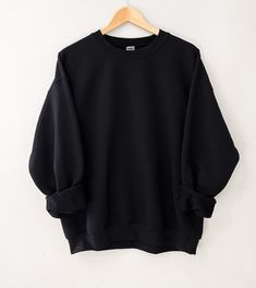 Made with the softest materials, this sweatshirt is designed to keep you warm and comfortable all season long. Whether you are lounging at home or running errands, this sweatshirt will be your go-to choice. Sizing: Small 4-6 Medium 8-10 Large 12-14 XL 14-16 Black Fleece Sweats With Relaxed Fit, Black Relaxed Fit Fleece Sweats, Solid Color Fleece Sweats For Everyday, Fleece Sweats For Everyday, Oversized Comfortable Black Sweater, Comfortable Oversized Black Sweater, Solid Color French Terry Sweatshirt For Athleisure, Solid Color Fleece Athleisure Sweater, Solid French Terry Sweatshirt For Athleisure