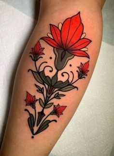 a red flower tattoo on the leg